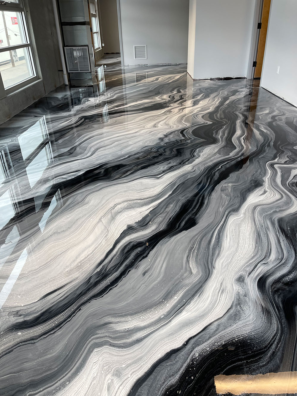 photo of a beautifully designed concrete surface with dye and polish for the perfect finish