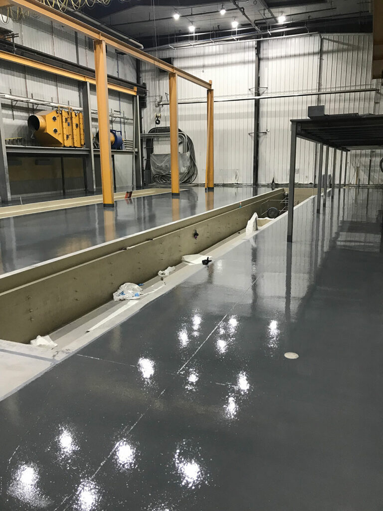 photo of a completely resurfaced concrete floor in an industrial shop in Edmonton