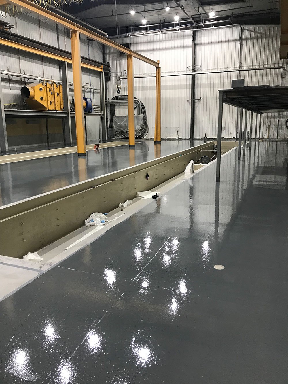 photo of a completely resurfaced concrete floor in an industrial shop in Edmonton